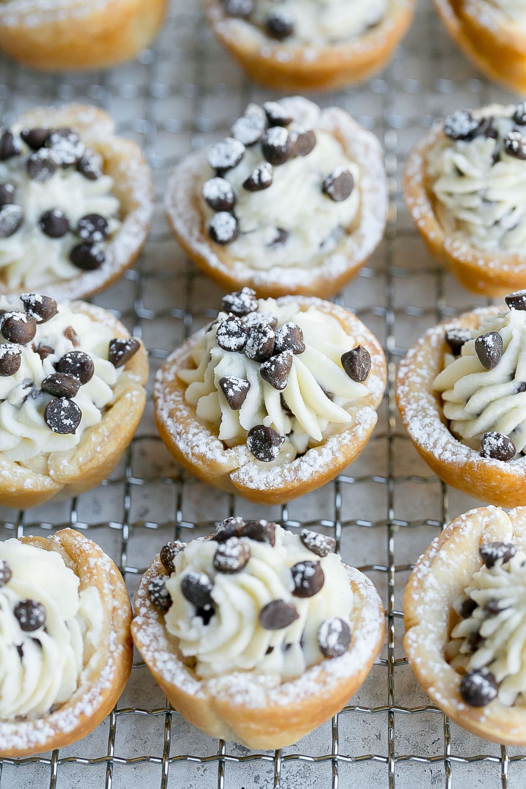 Cannoli bites on a wire cooling rack.