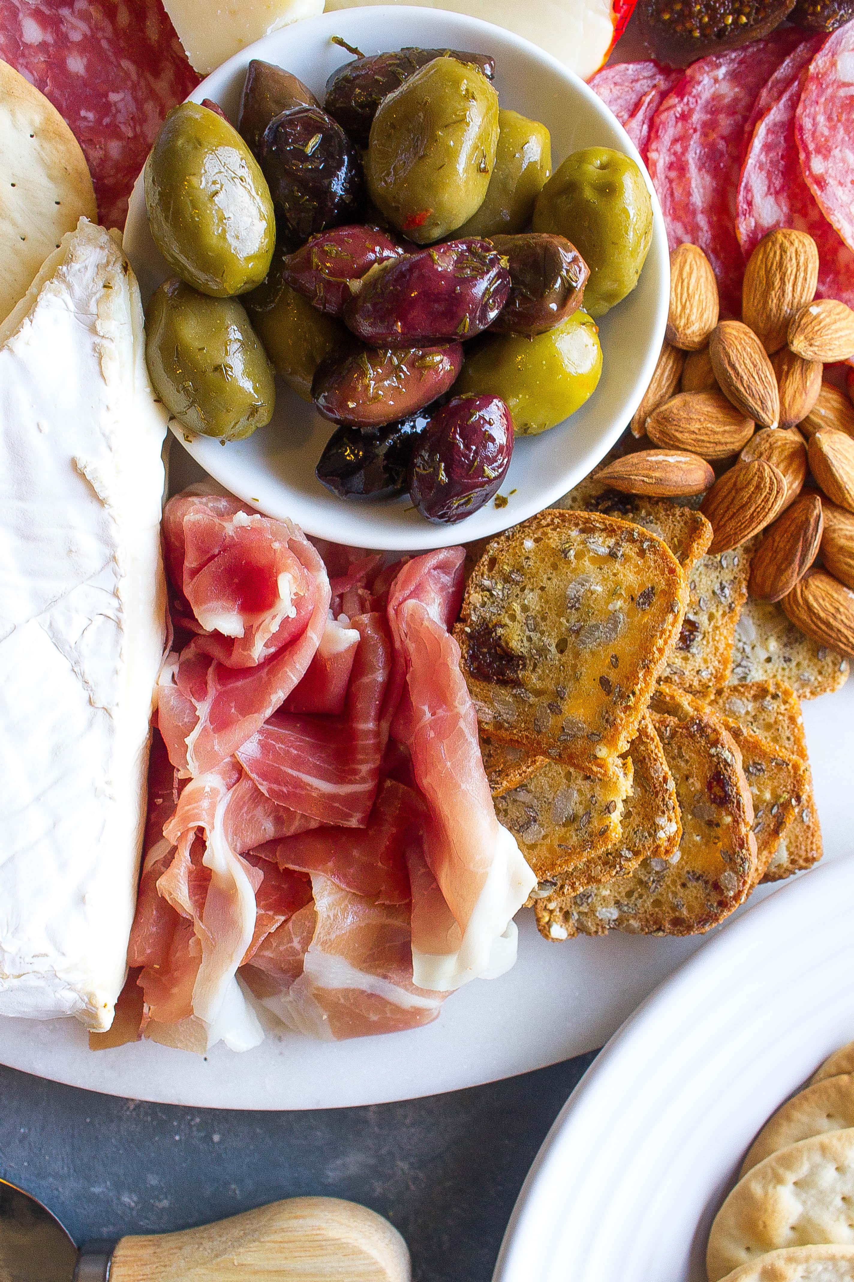 Cheese plate with prosciutto and olives