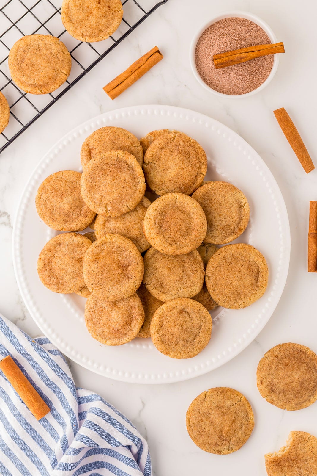Buttery snickerdoodles on a white plate.