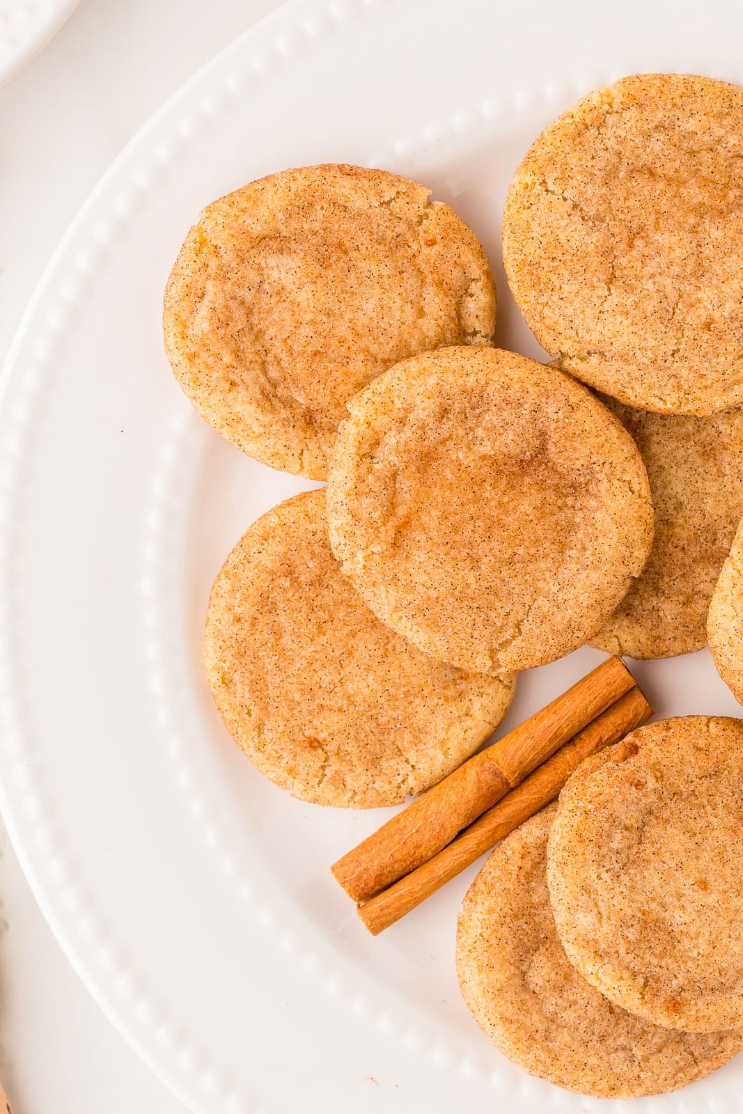 Plate of classic snickerdoodles and a cinnamon stick.