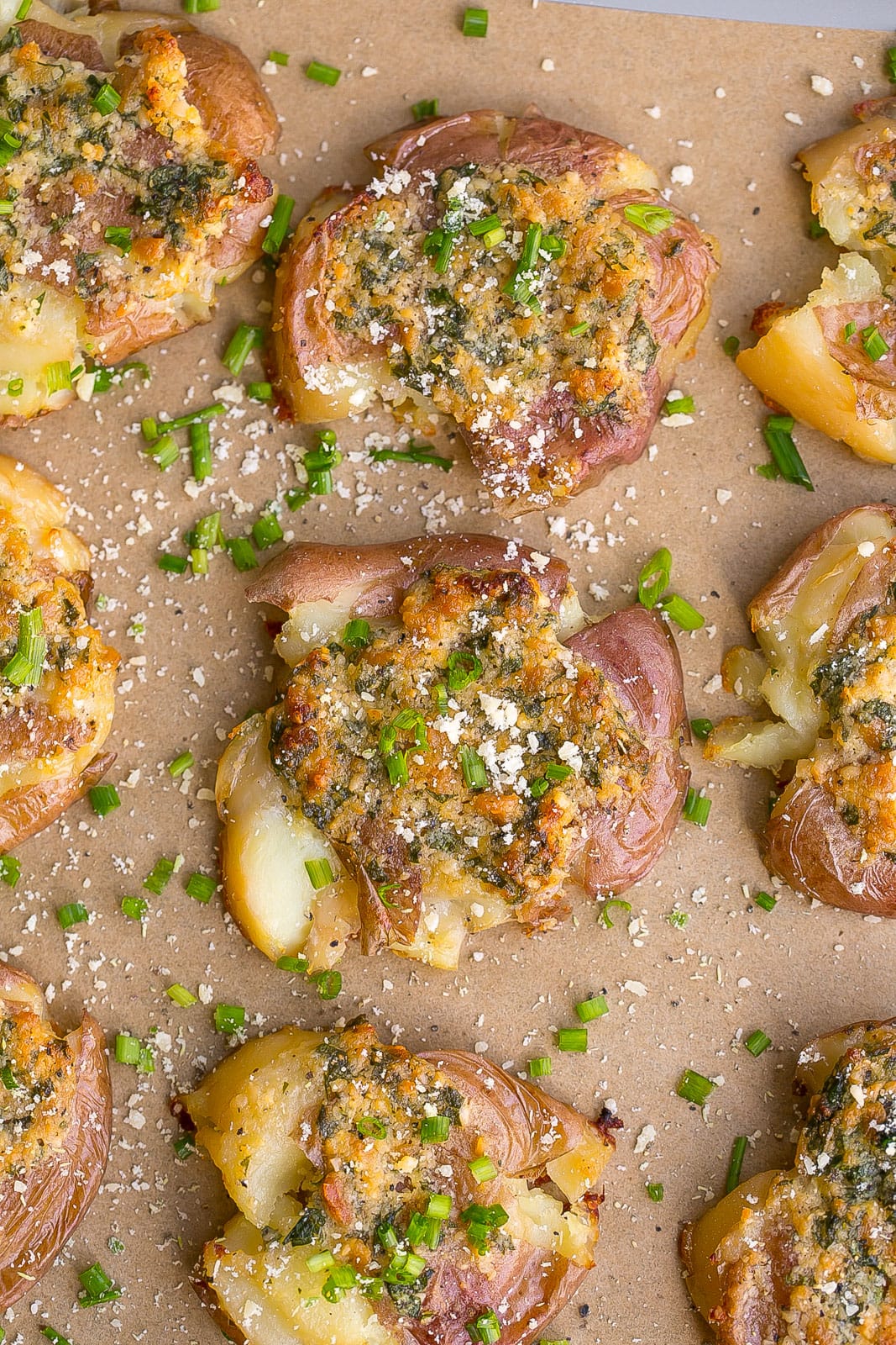 Garlic Parmesan Smashed Potatoes on parchment paper.