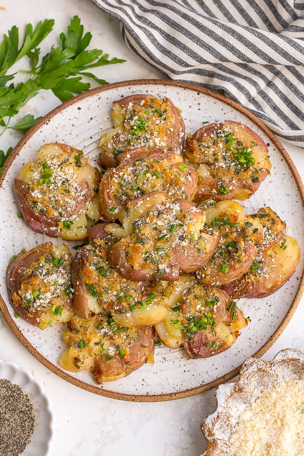 Plate of parmesan cheese smashed potatoes. 