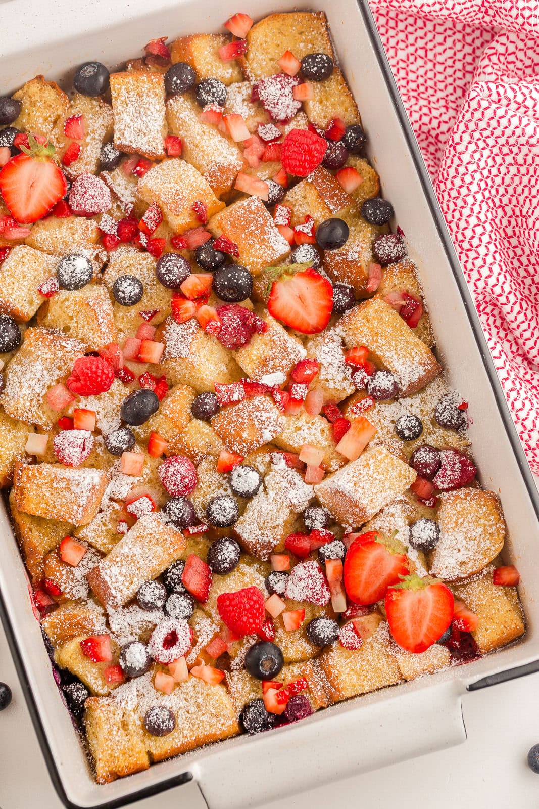 Triple Berry French Toast Bake with powdered sugar on top.