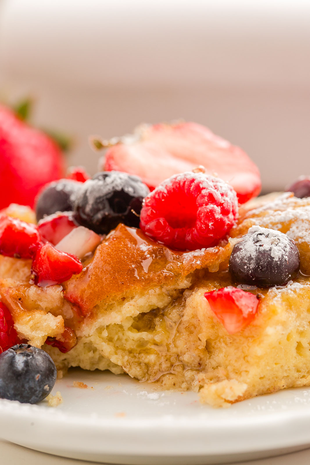 Close up view of a bite of Hawaiian roll french toast casserole.