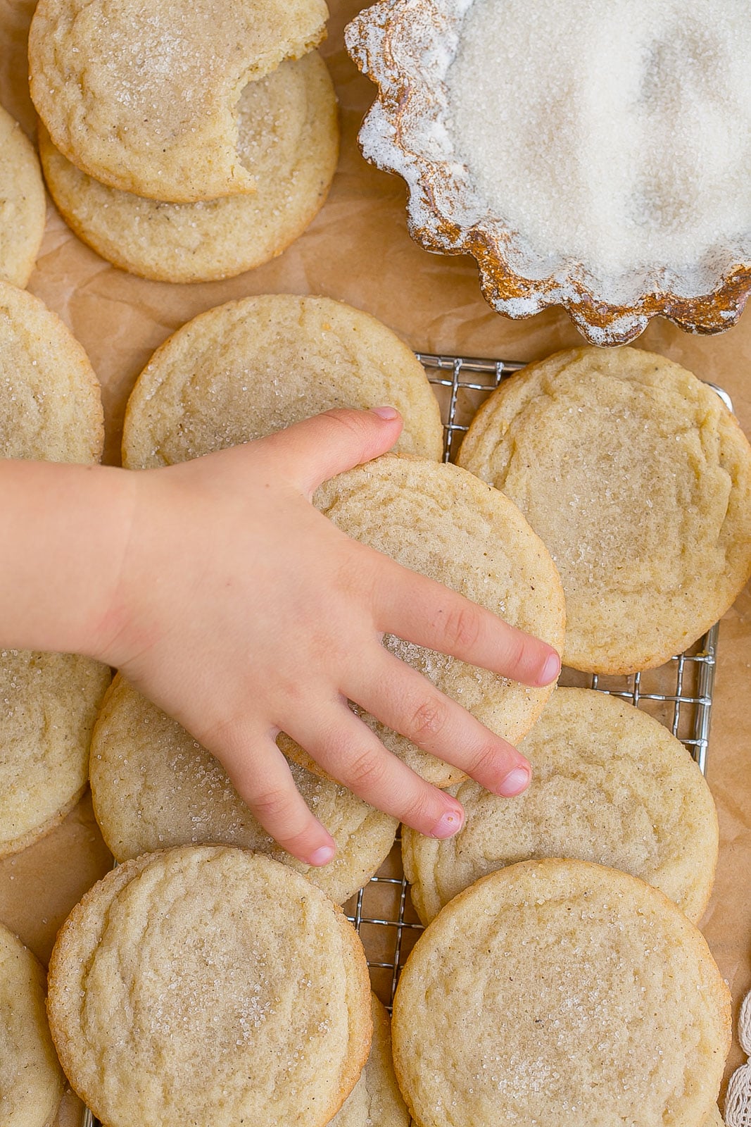 Small hand grabbing cookie.