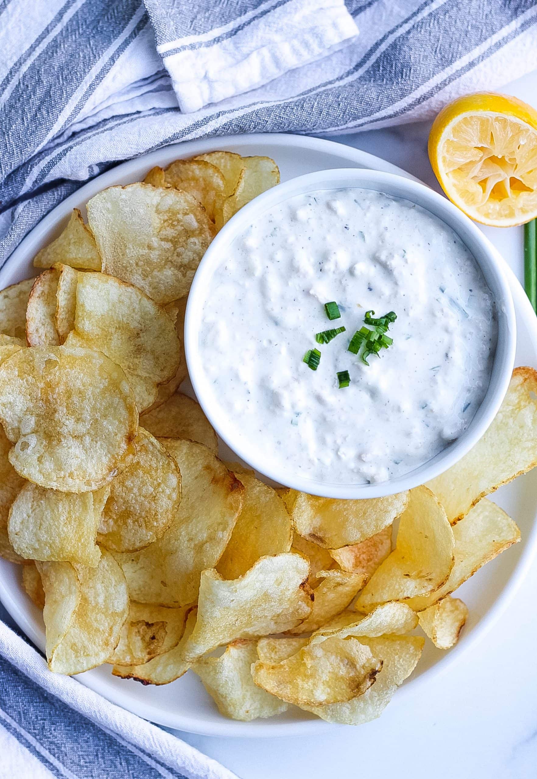 plate of chips with a dish of clam and cream cheese dip