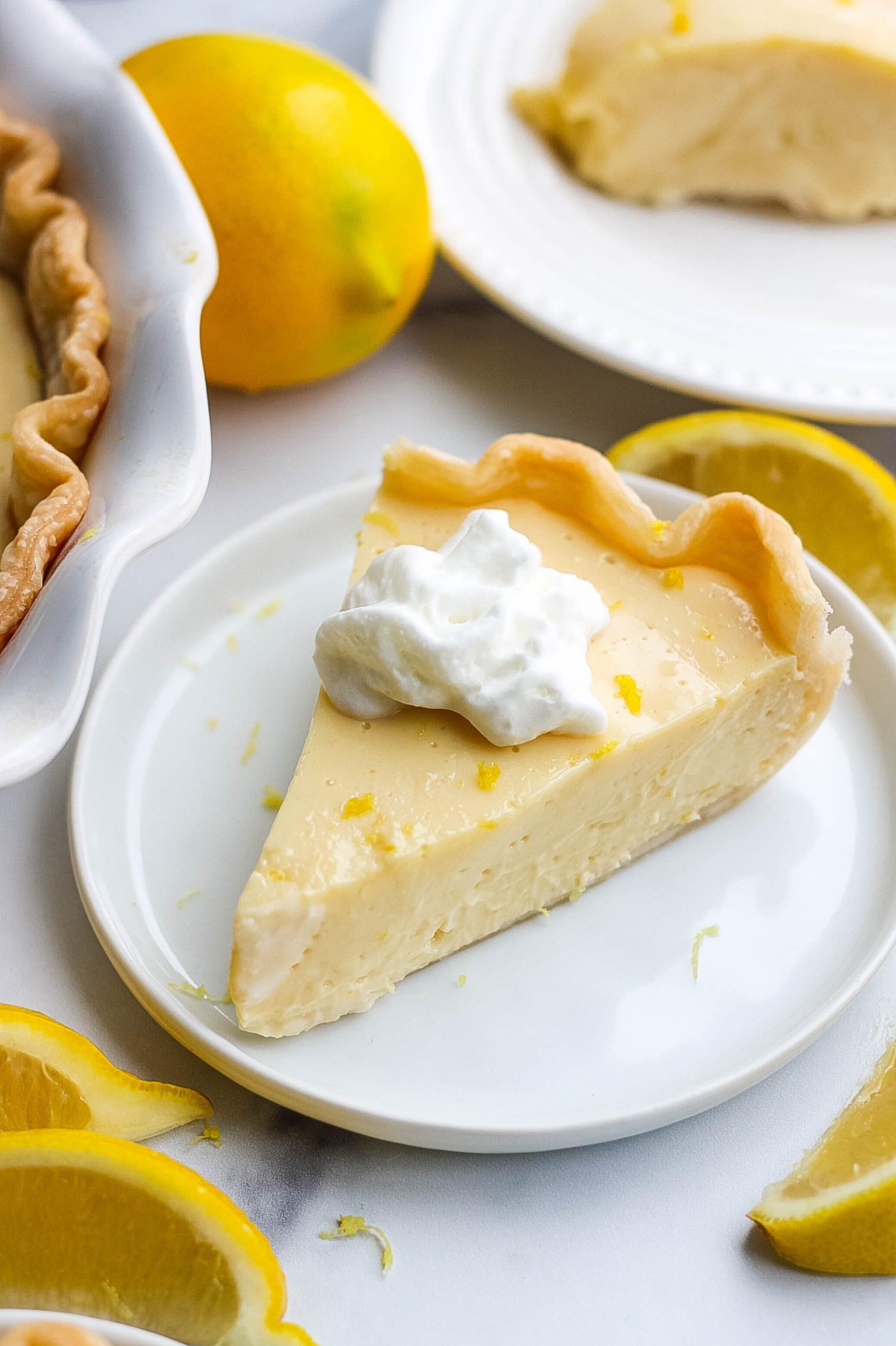 slice of lemon pie with zest and whipped cream