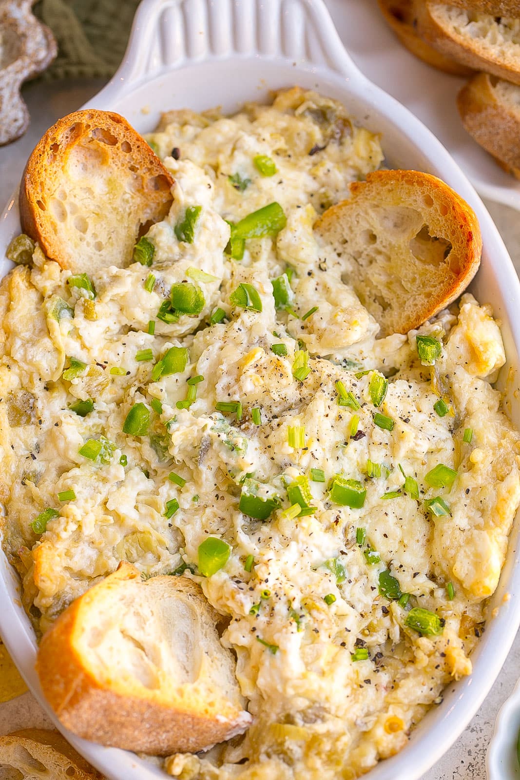 A serving bowl with spicy artichoke dip.