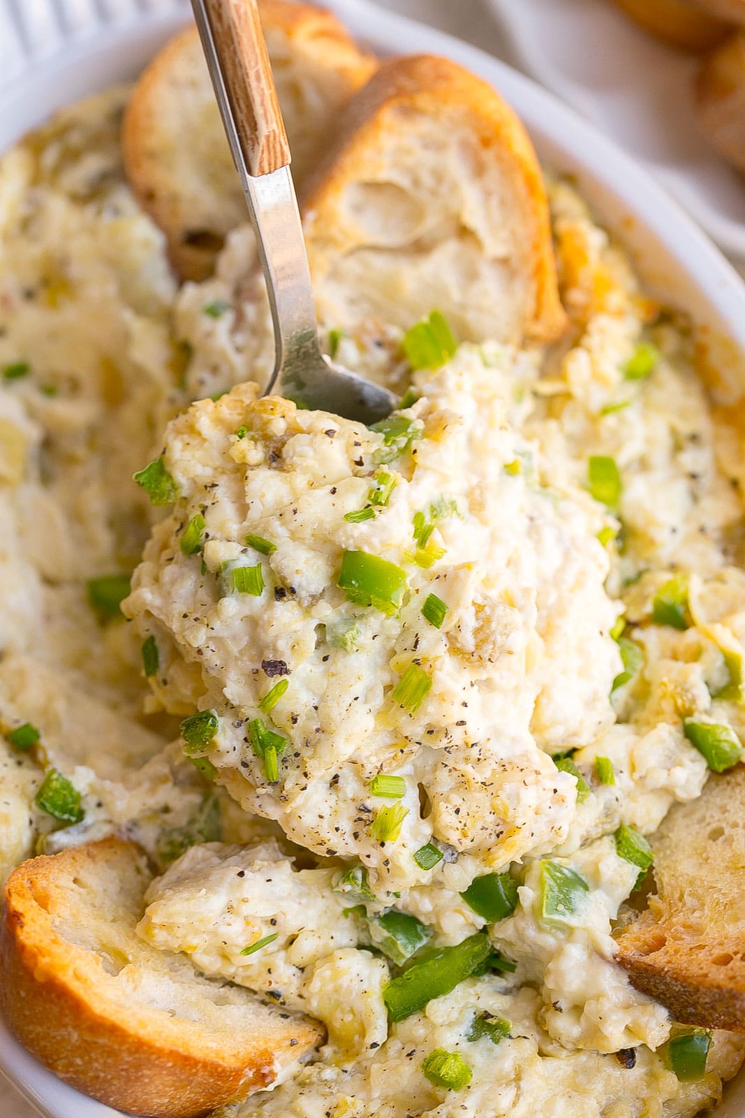 Jalapeño Artichoke Dip on a serving spoon.