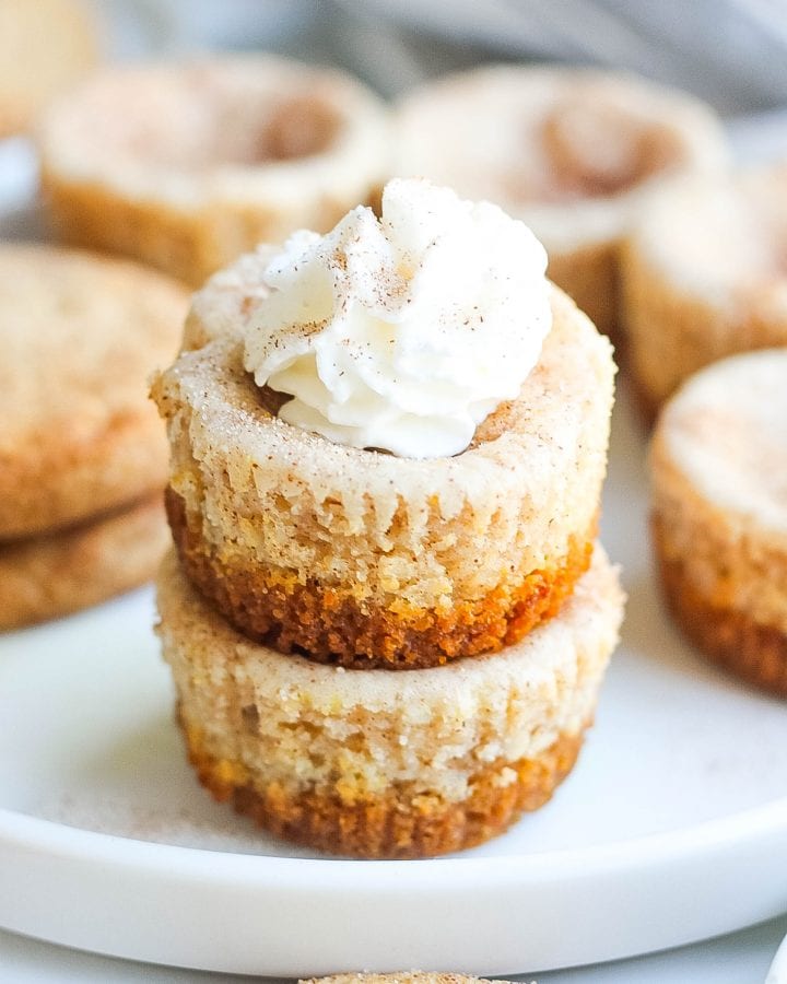 stack of snickerdoodle cheesecake bites with whipped cream