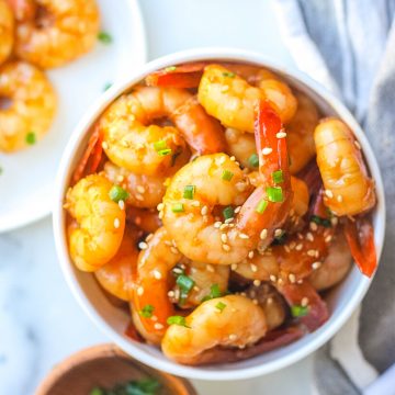 one bowl of honey garlic shrimp with green onions