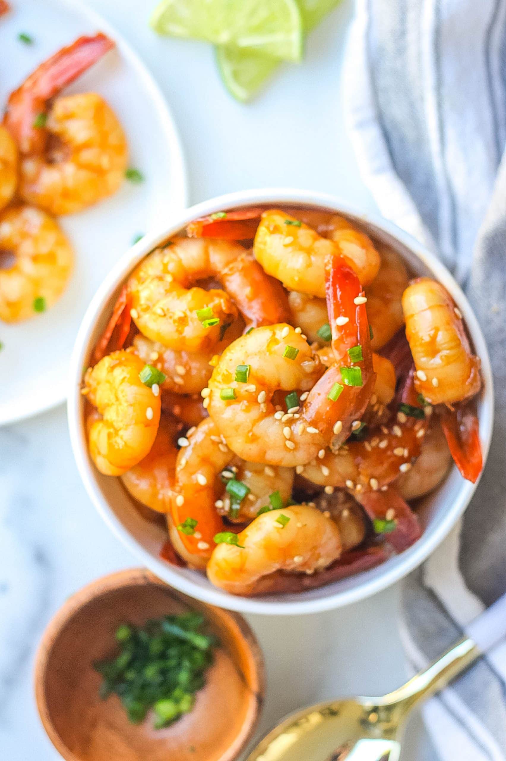 honey garlic shrimp in white bowl with sesame seeds 
