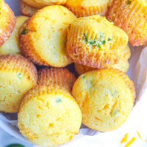 white bowl filled with cornbread muffins with cheddar and jalapeño