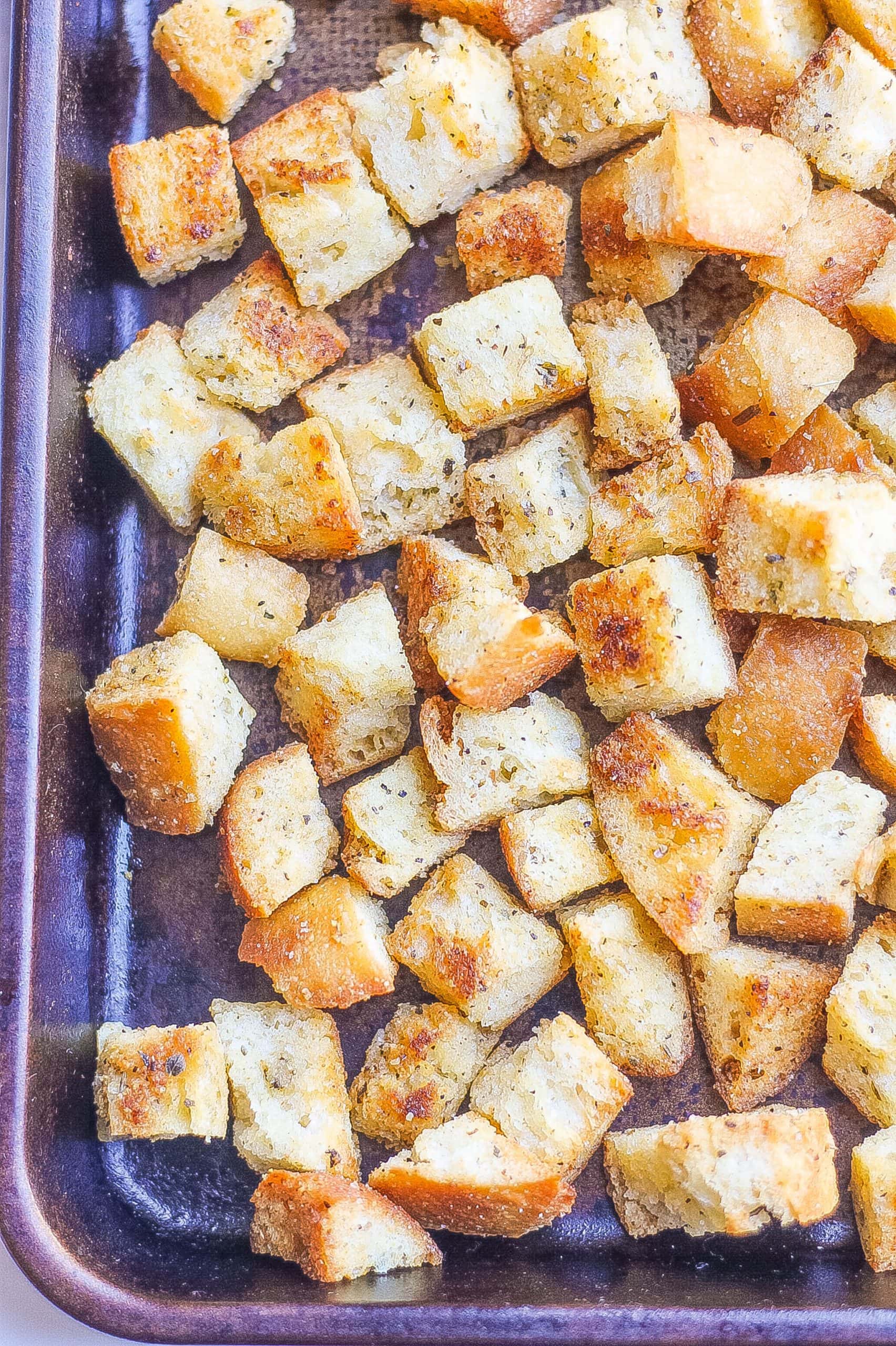 close view of crispy baked homemade croutons recipe on baking sheet