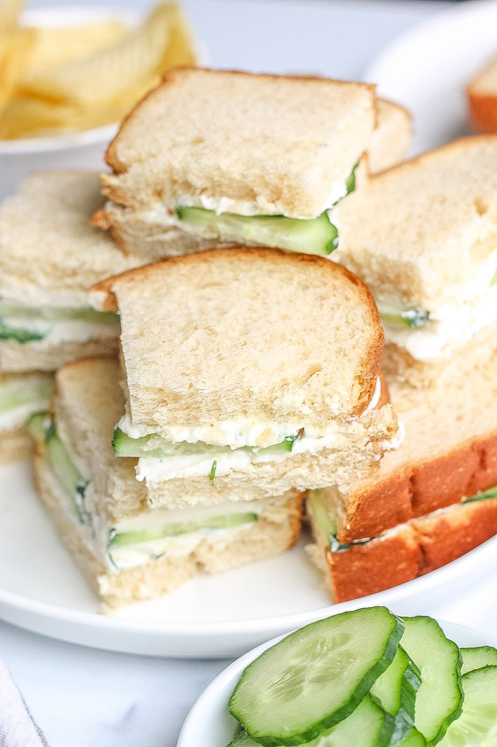 cucumber sandwiches stacked on plate