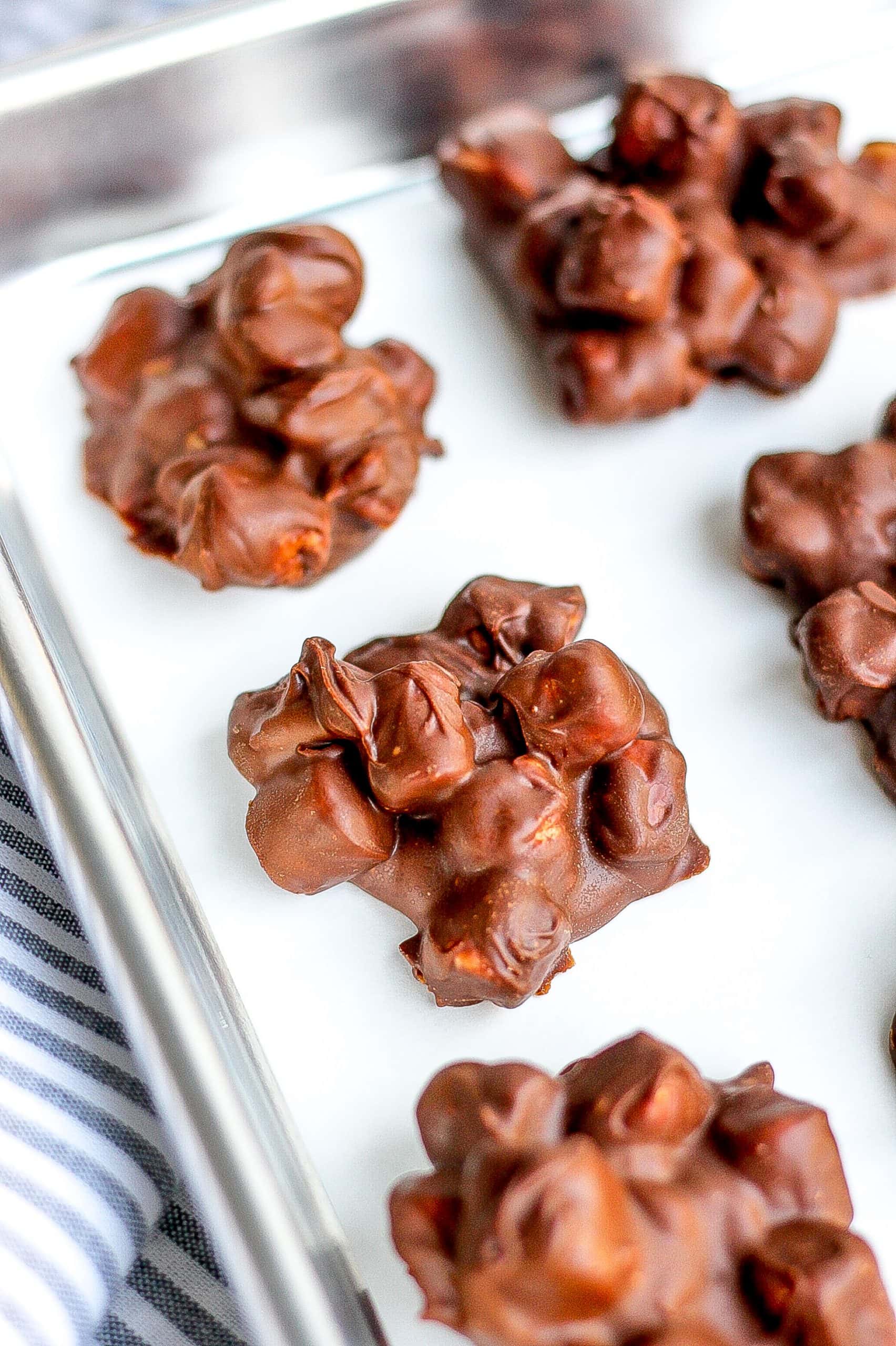 clusters of rocky road candy on parchment paper on baking sheet