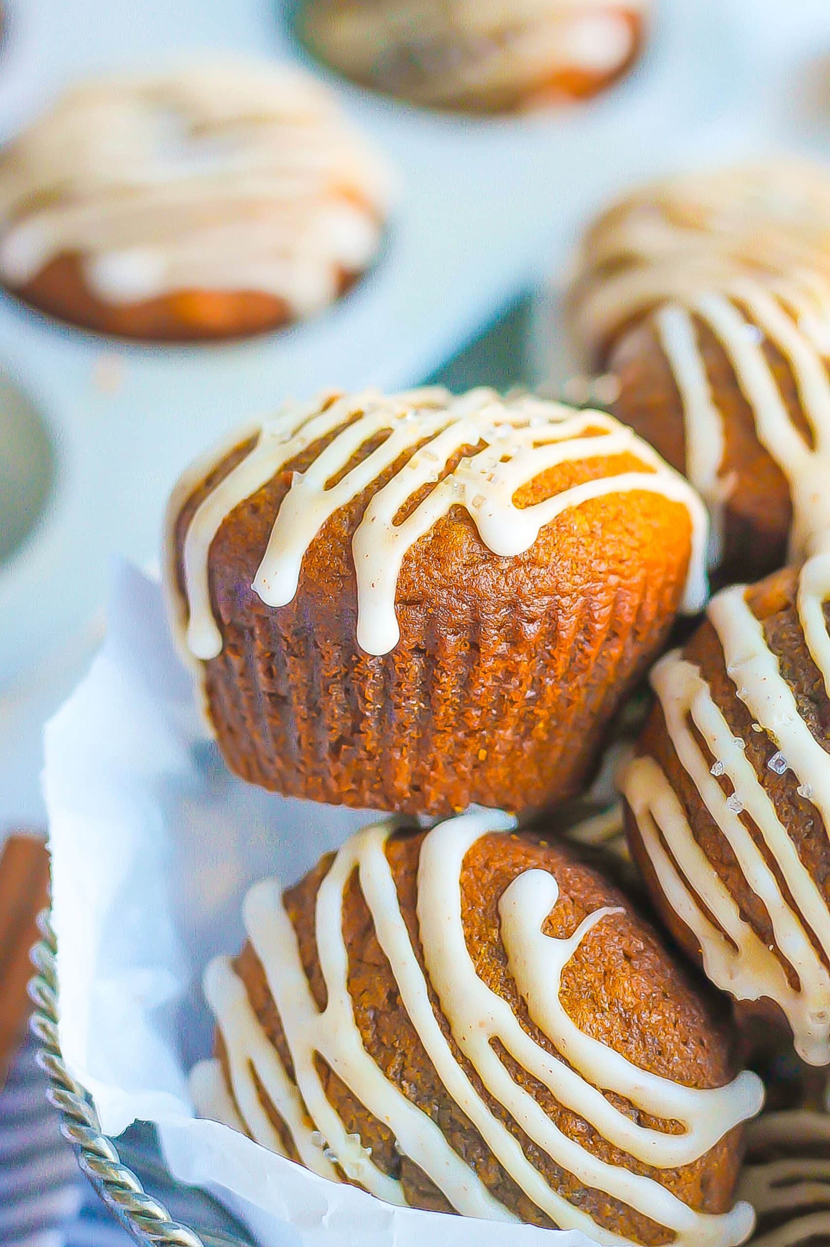 side view of basket filled with gingerbread muffins with icing drizzle
