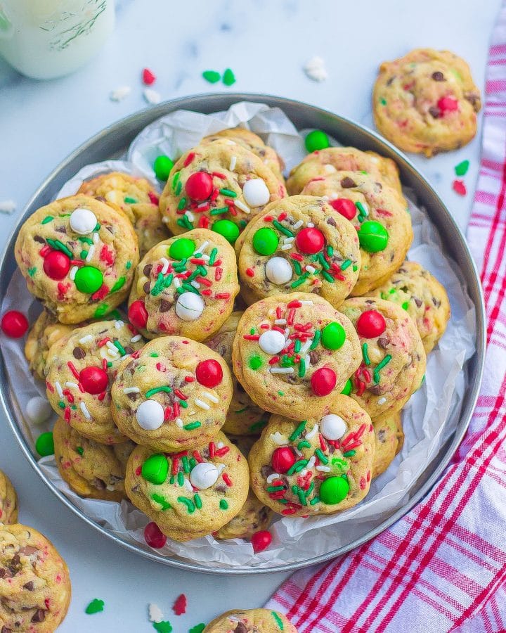 one tray filled with baked Santa cookies with M&Ms, sprinkles, and chocolate chips