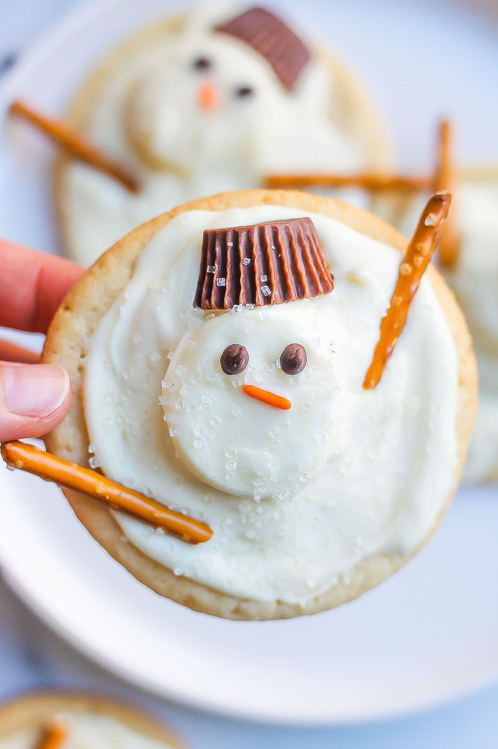 one close up image of snowman cookies with Reese's and pretzel cookies 