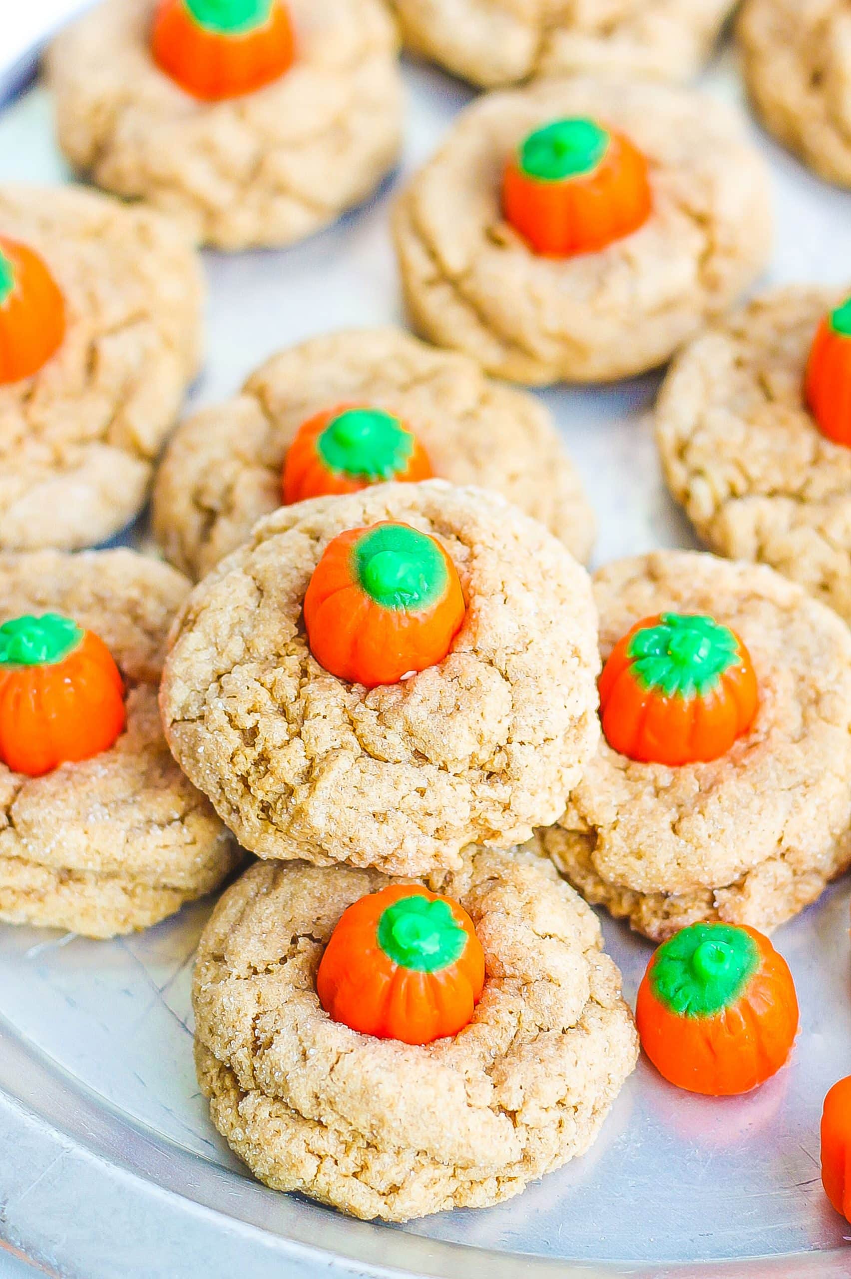 Spice Cookies with pumpkin candies on sliver platter. 