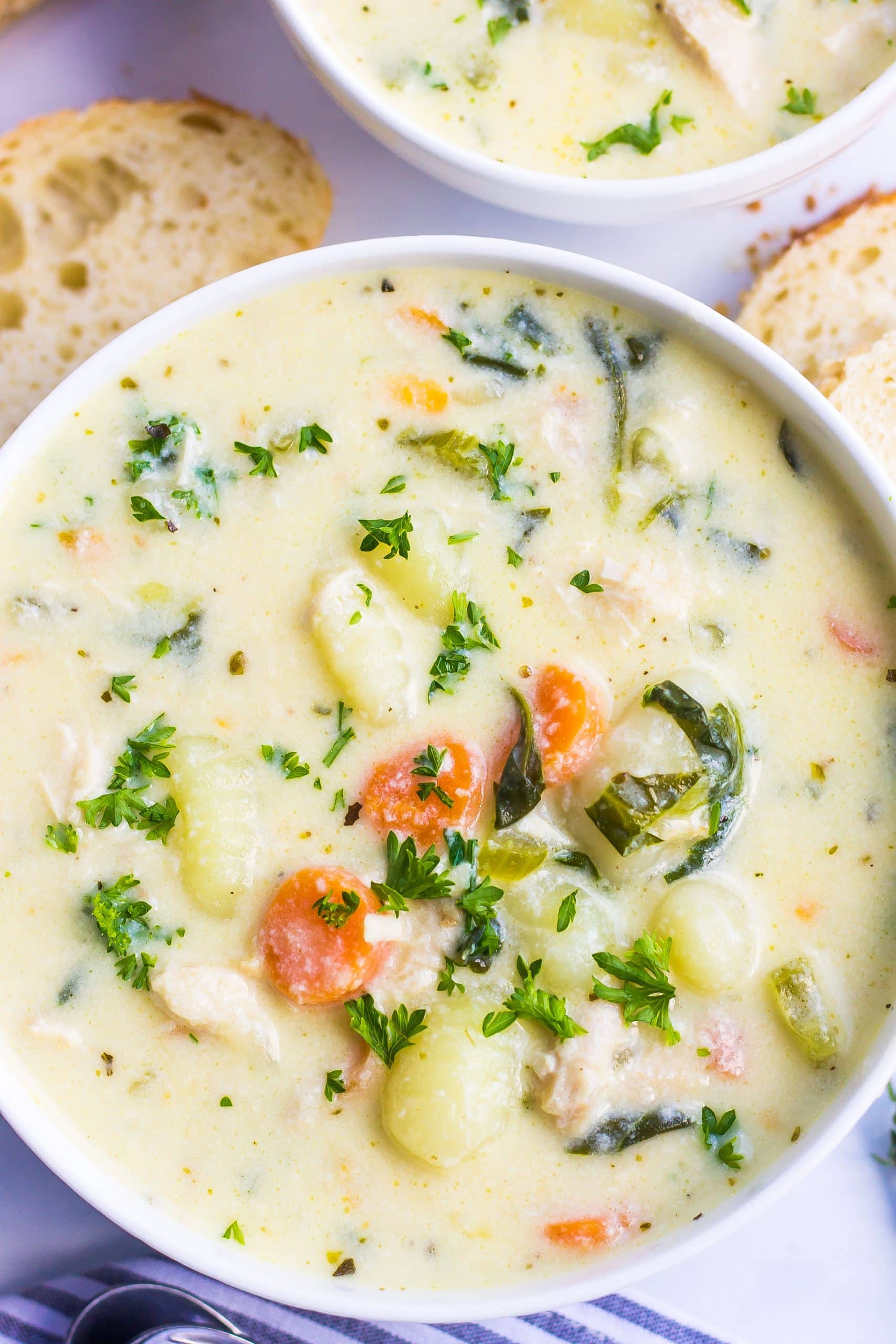 one bowl of chicken gnocchi soup with carrots and parsley