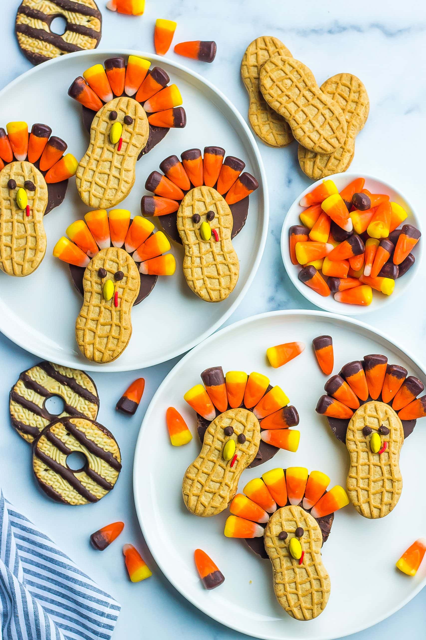 thanksgiving turkey cookies on 2 circular white serving dishes