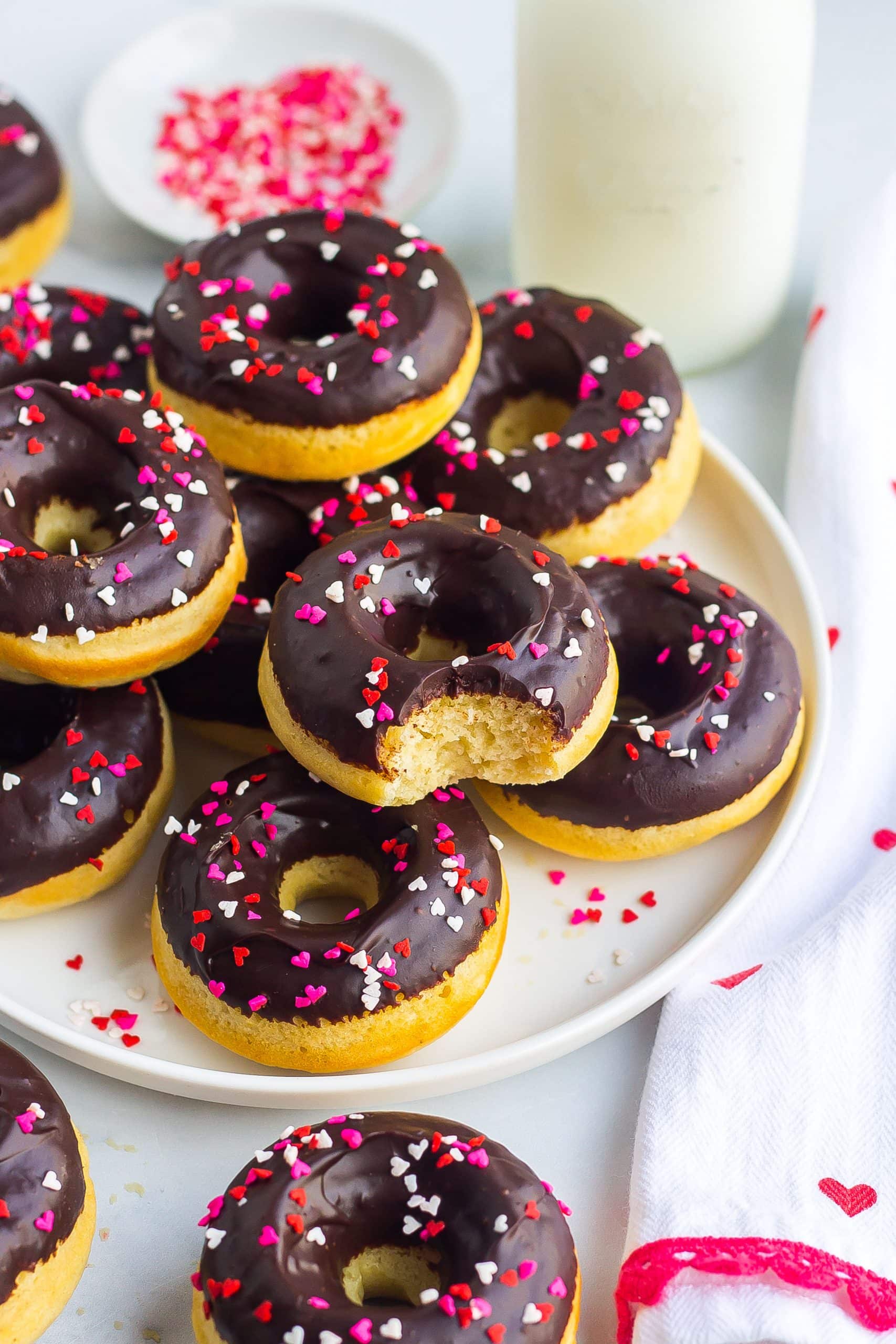 plate of donuts with chocolate icing and sprinkles 