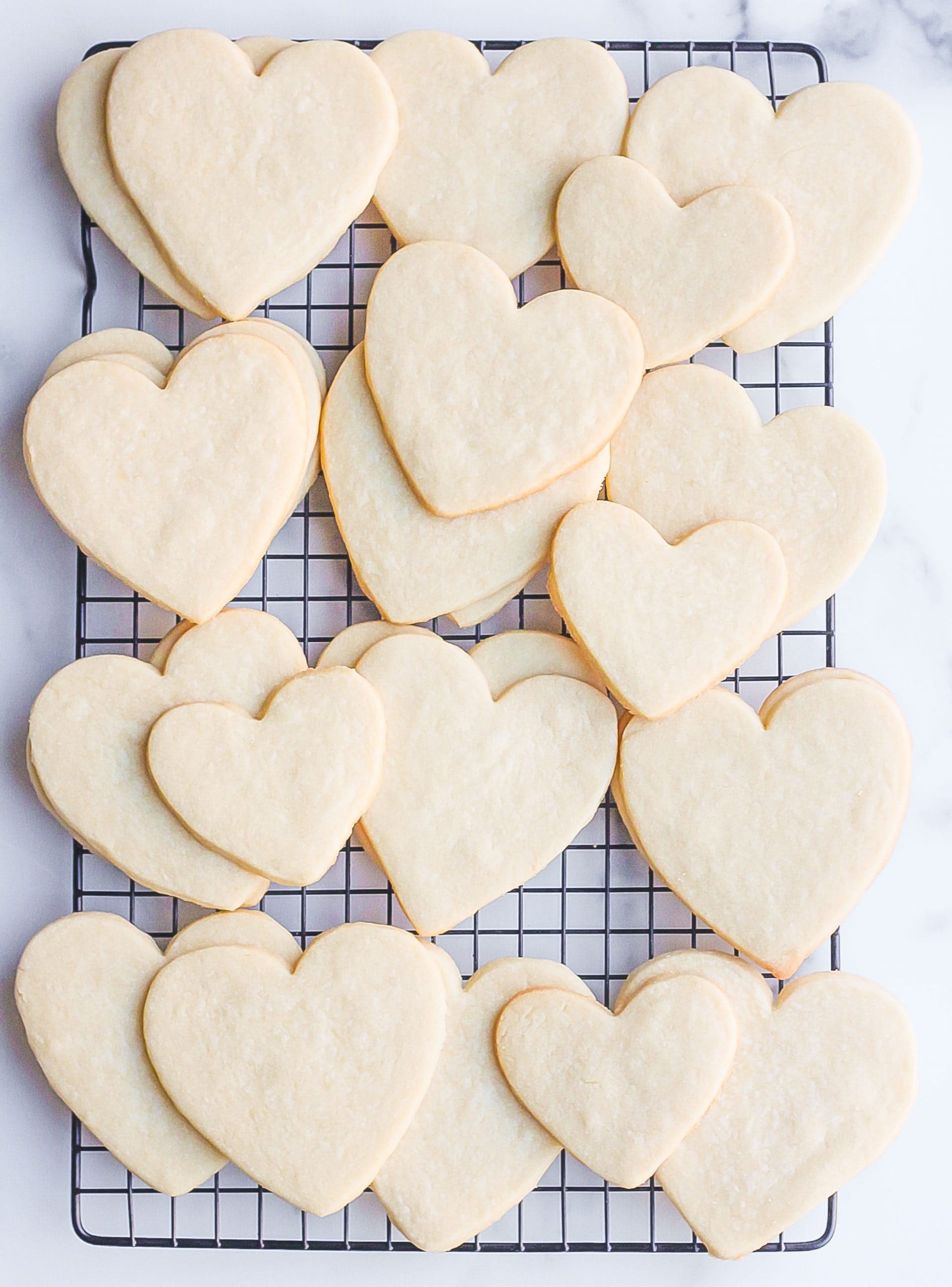 Unfrosted cut-out sugar cookies on cooling rack
