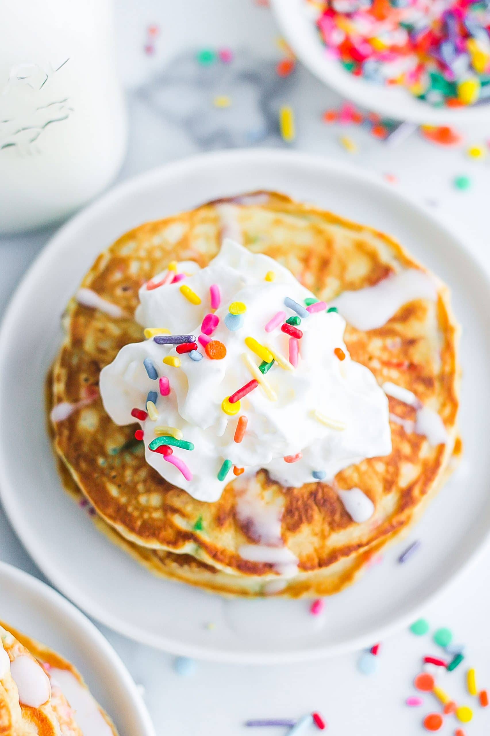 Birdseye view of funfetti pancakes with whipped cream