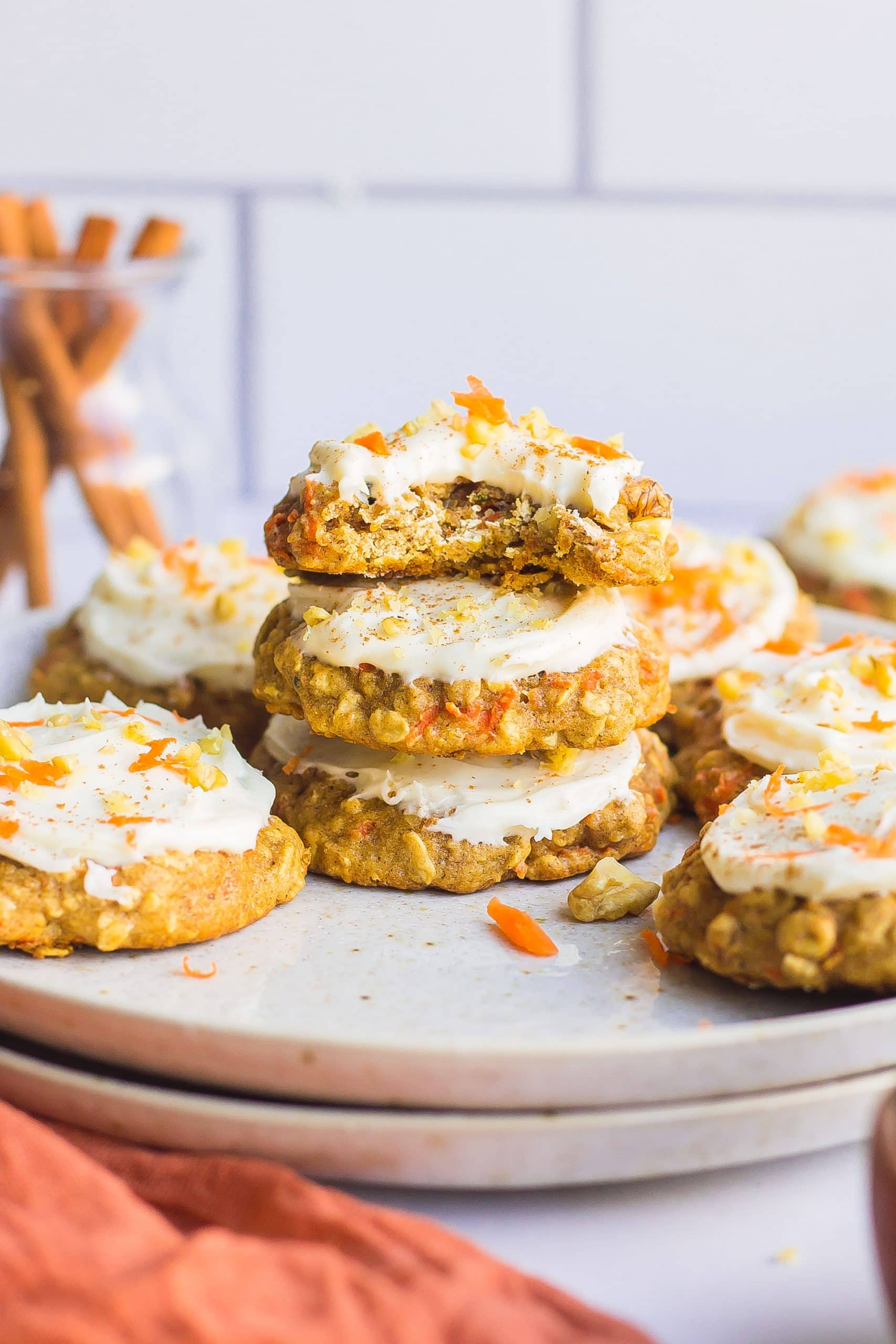 stack of frosted carrot cake cookies