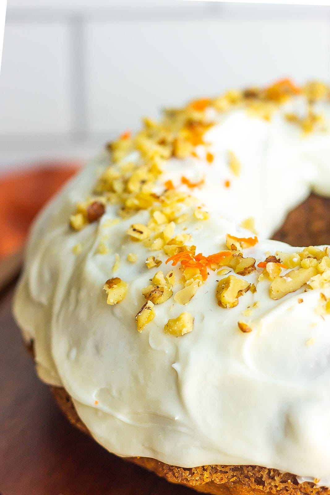 frosted carrot cake with walnuts on top