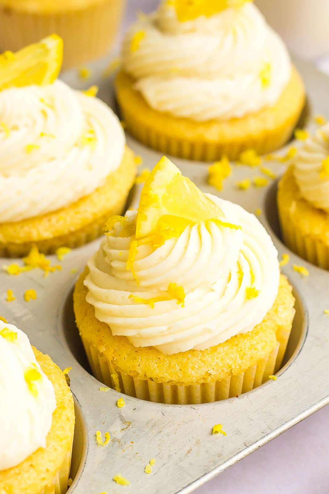 close up of frosted cupcakes with lemon zest on top