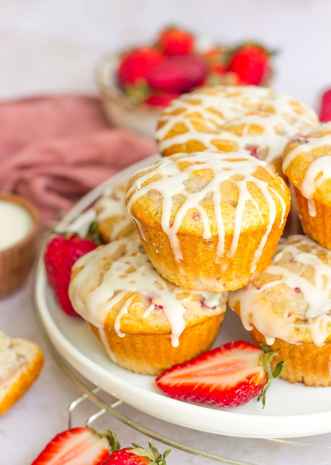pile of strawberry yogurt muffins with glaze on top