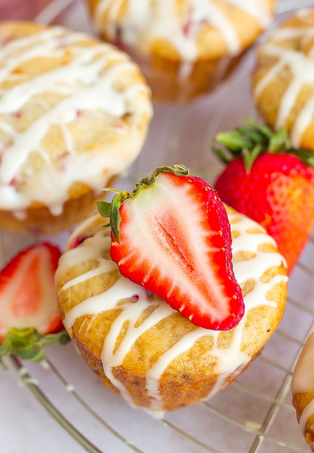 strawberry on top of a glazed muffin