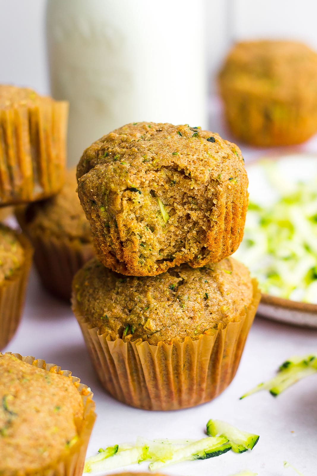 Healthy Zucchini Muffins stacked with a bite mark
