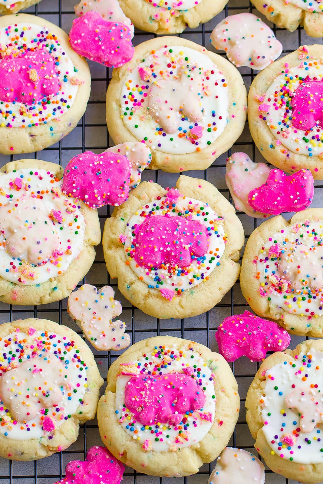 frosted sprinkled sugar cookies on cooling wrack with frosted circus animal cookies