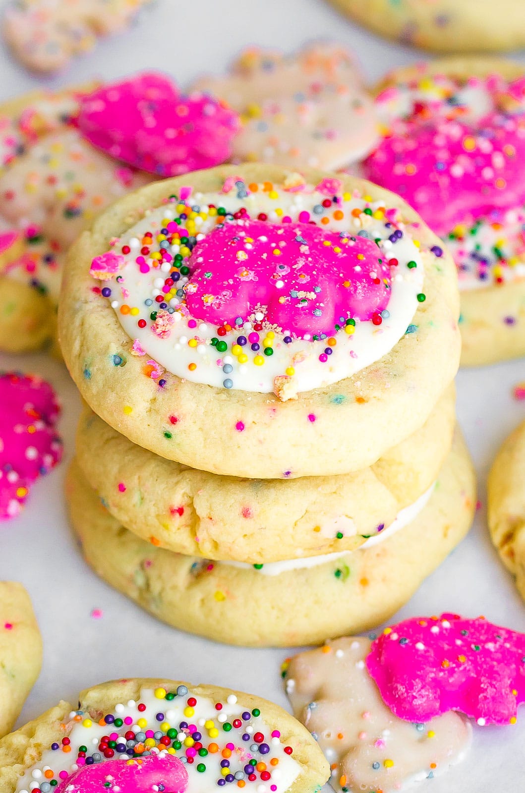 stacked sprinkled sugar cookies with white chocolate frosting, circus animal cookies, and sprinkles