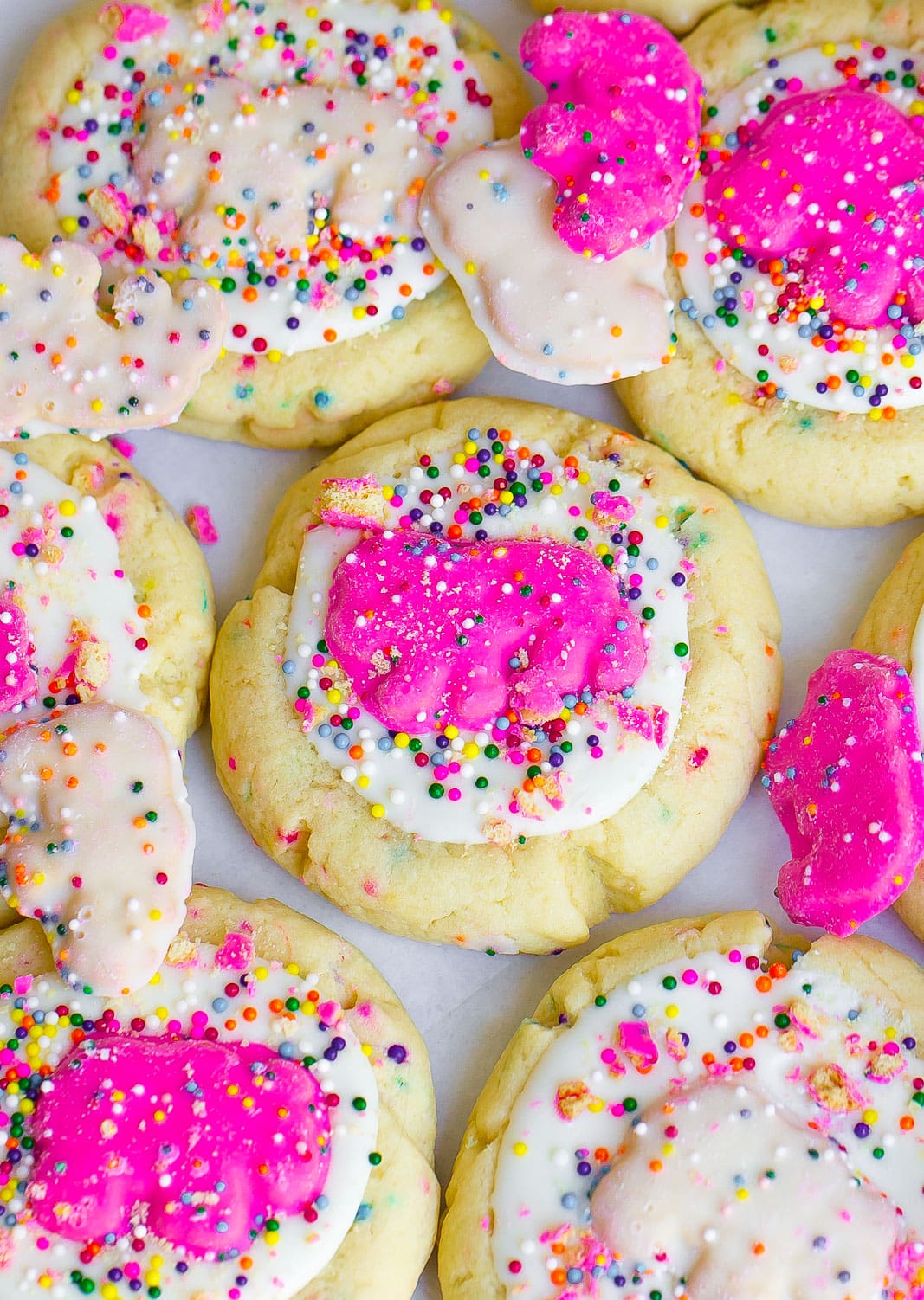 frosted sugar cookies with circus animal cookies and white chocolate on top. 