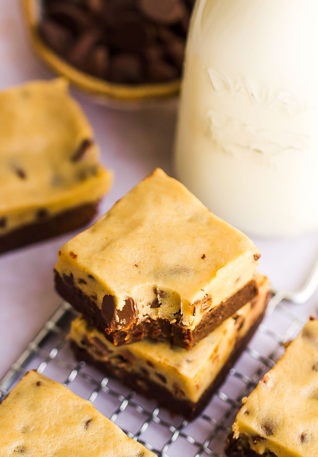 chocolate chip cookie dough brownies on a cooling rack with a bite mark 
