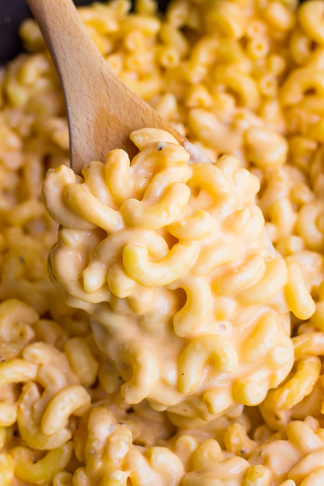 Creamy Macaroni and Cheese on a wooden spoon