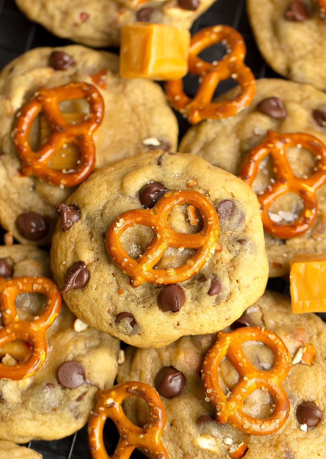 Close up of chocolate chip cookies with pretzels and caramel.
