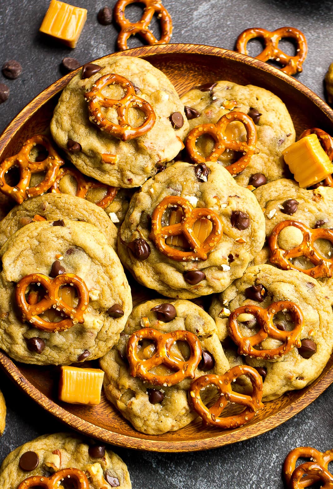 Large wooden plate full of Chocolate Chip Pretzel Cookies.