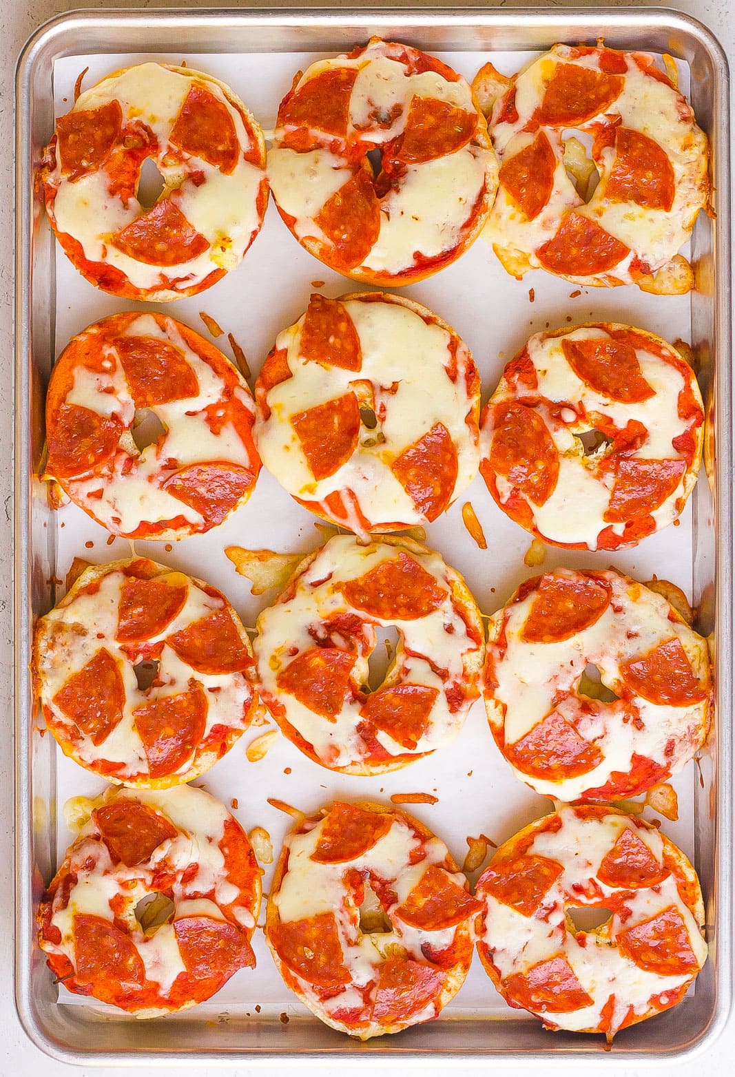 mini pizza bagels on a baking sheet