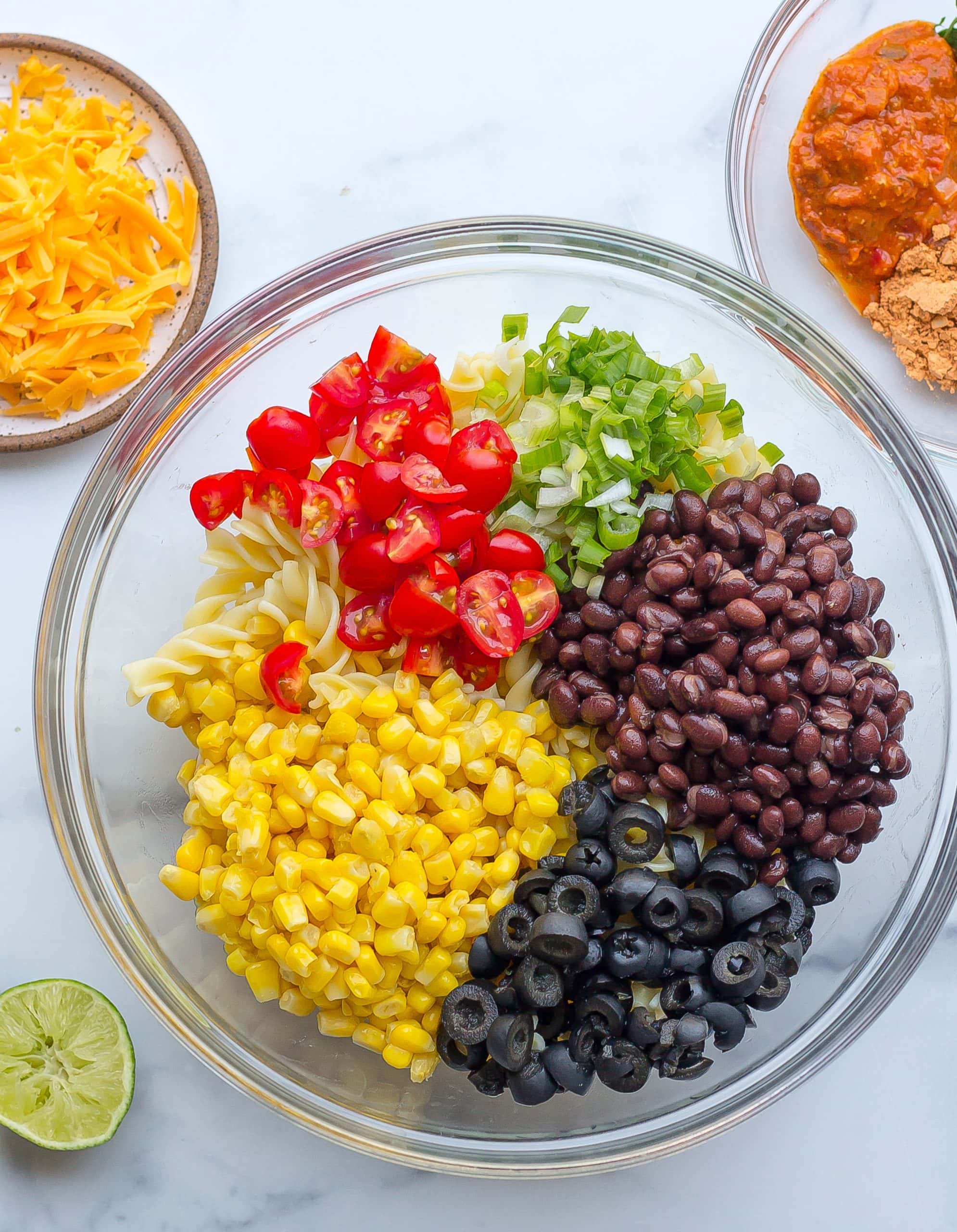 taco pasta salad recipe ingredients in a glass bowl