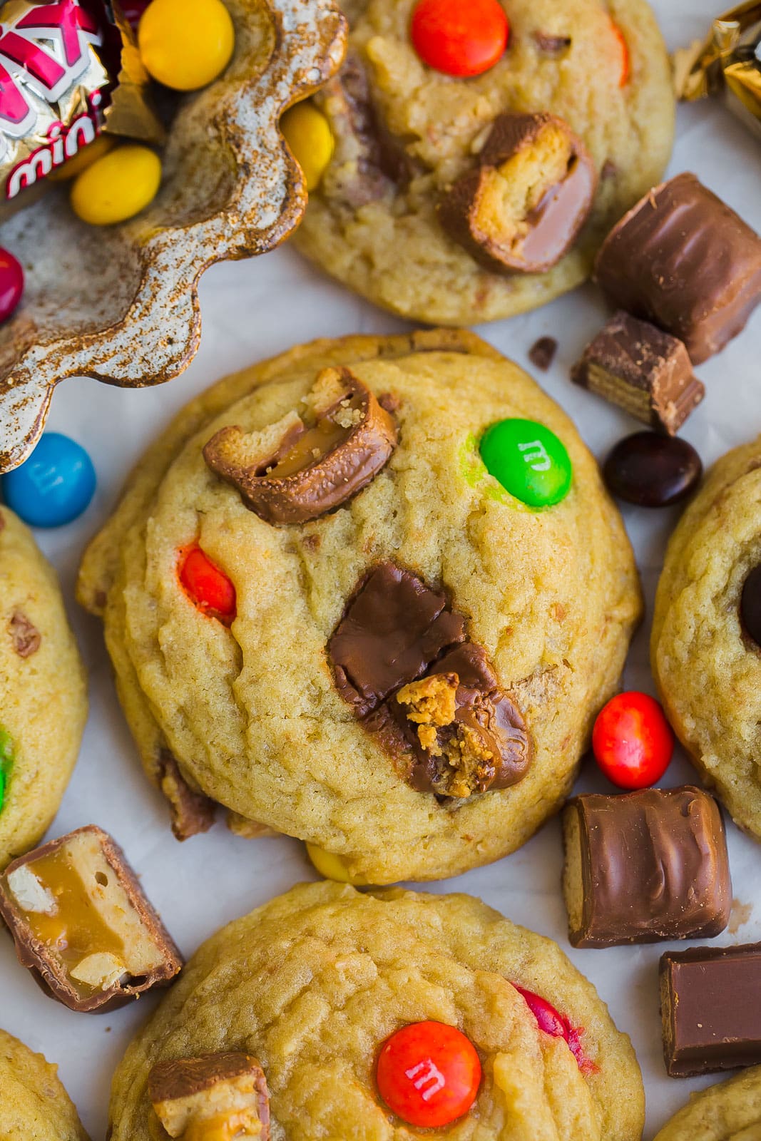 Close up of candy bar cookies with melted chocolate on center. 