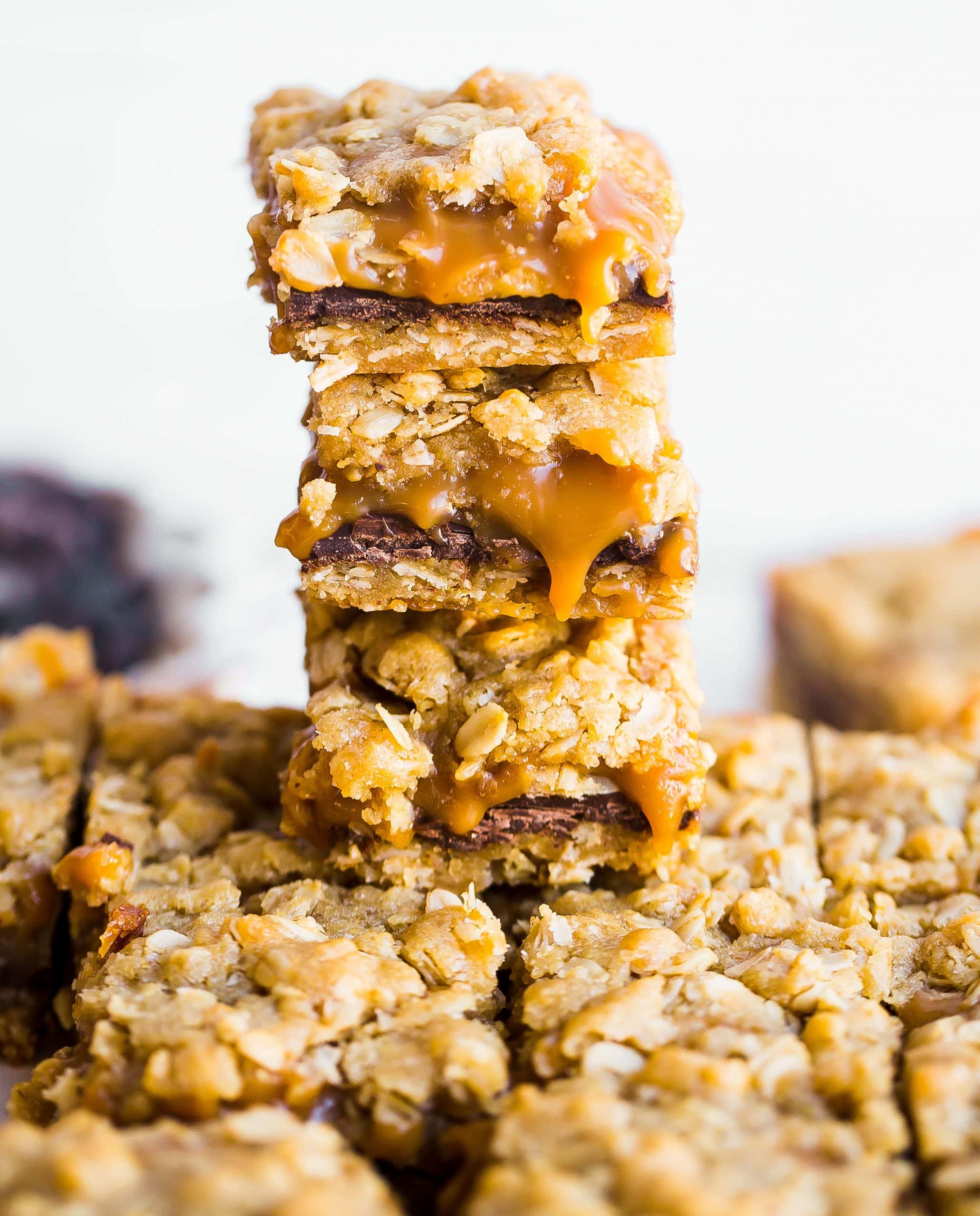 Stack of Oatmeal Caramel Chocolate Bars with gooey caramel coming out of the centers.