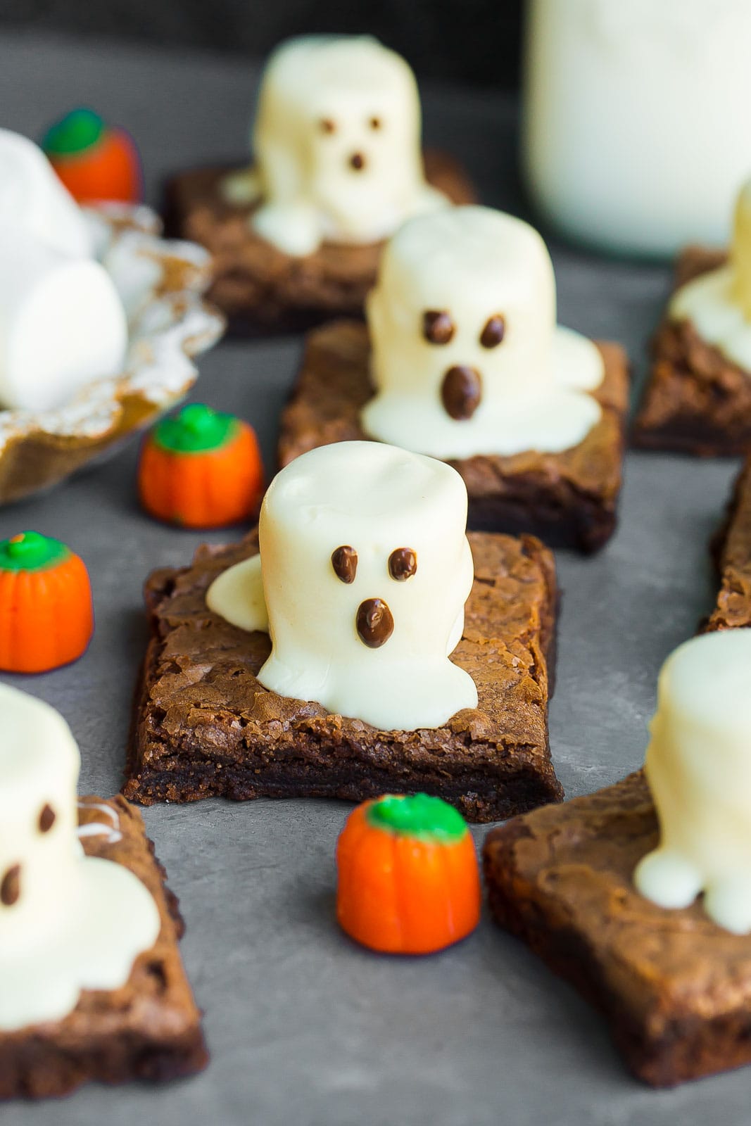 Close up of ghost brownie with candy pumpkin.