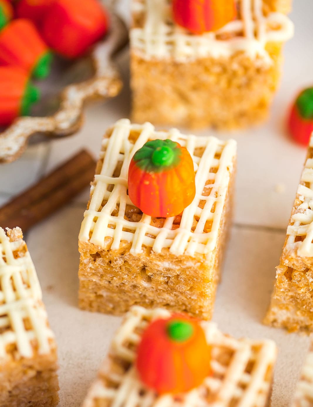 Fall themed rice krispie treats drizzled with white chocolate on top.