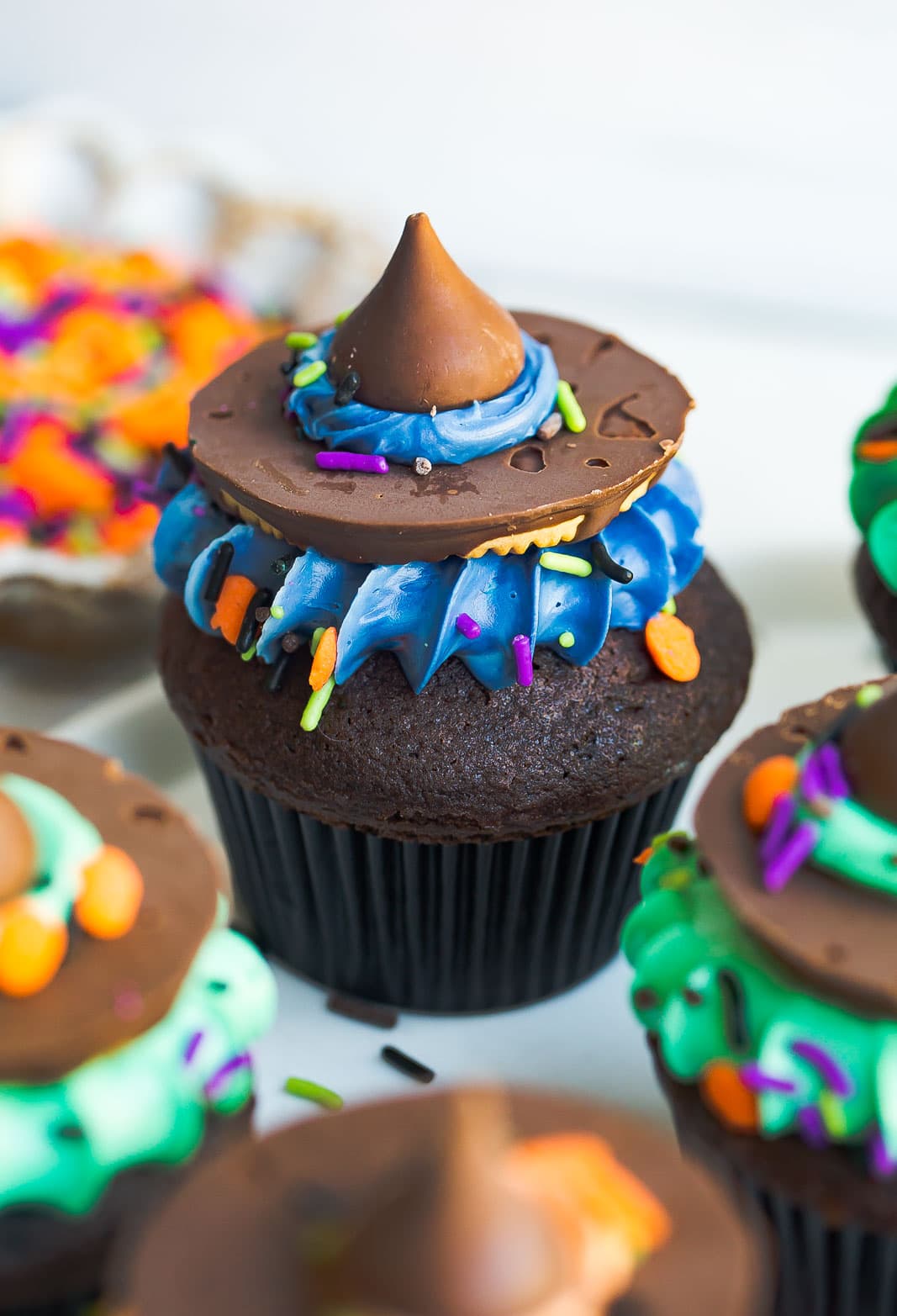 Chocolate cupcake with candy witch hat on top.