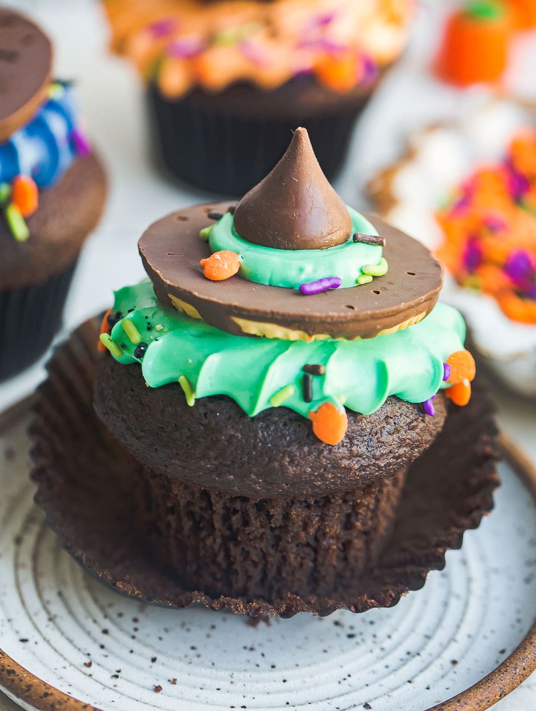 Halloween cupcakes unwrapped with witch hat on top.
